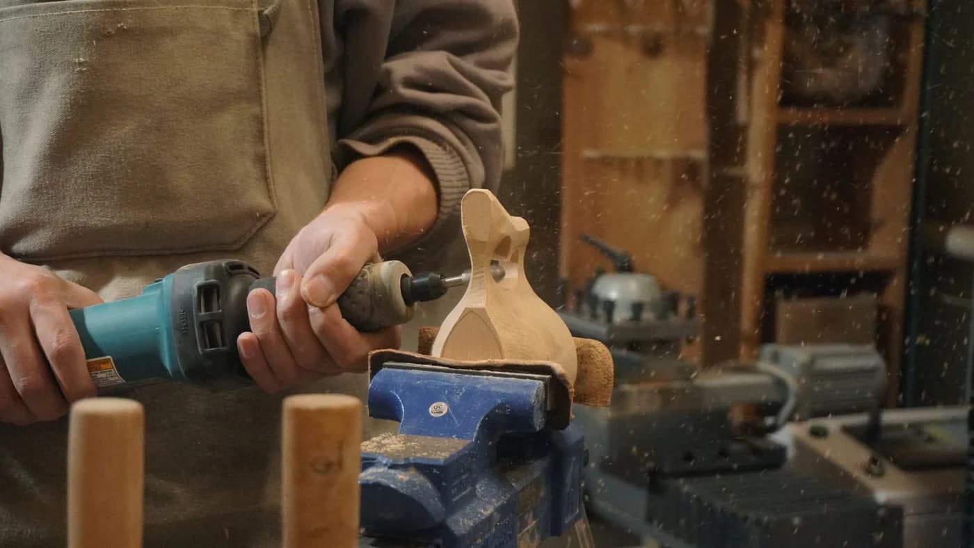 Shaping a wooden scoop at the Cobble Studio workbench
